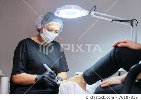 Mature woman on pedicure procedure in beauty salon Mature woman on pedicure procedure in beauty salon 76187819