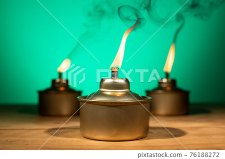 Pelita or oil lamp, traditional Malay oil lamp lit up with smoke during Ramadan and Hari Raya Aidilfitri Muslim celebration 76188272
