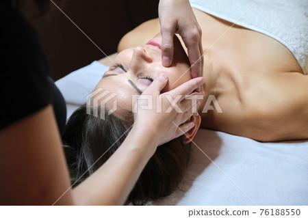 Mature woman face massage, beautician doing facial spa treatments Mature woman face massage, beautician doing facial spa treatments 76188550