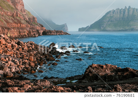 Dramatic view on Drangarnir and Tindholmur sea stacks Dramatic view on Drangarnir and Tindholmur sea stacks 76190681