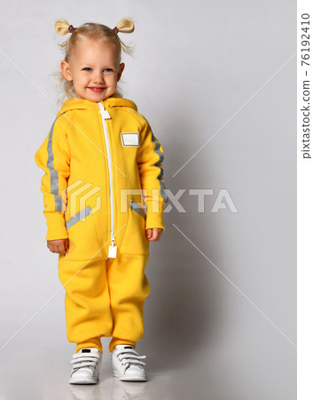 Little cute blonde girl in a warm comfortable 76192410