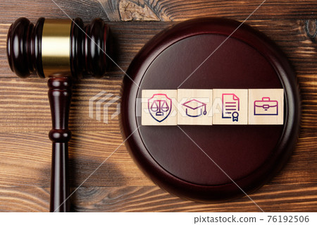 Judge gavel with legal activity concept on abstract wooden blocks with icons Judge gavel with legal activity concept on abstract wooden blocks with icons 76192506