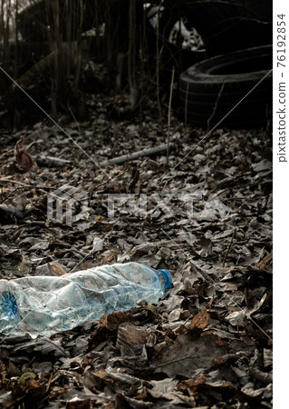 Ecology background. Plastic waste rubbish in forest, woodland. Garbage trash in environment. Empty used dirty bottles. Ecological problem. Ecology background. Plastic waste rubbish in forest, woodland. Garbage trash in environment. Empty used dirty bottles. Ecological problem. 76192854