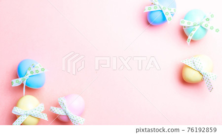 Easter border. Colorful egg with tape ribbon on pastel pink background in Happy Easter decoration. Flat lay, top view. Easter border. Colorful egg with tape ribbon on pastel pink background in Happy Easter decoration. Flat lay, top view. 76192859