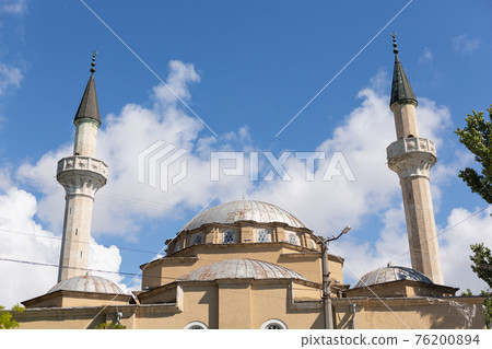 the dome of the mosque and two minarets against the blue sky with clouds, the religion 76200894