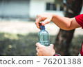 Man opening bottle of water 76201388