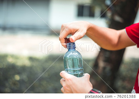 Man opening bottle of water 76201388