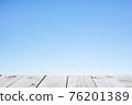 Wood plank table top on blue background 76201389