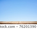 Wood plank table top on blue background 76201390