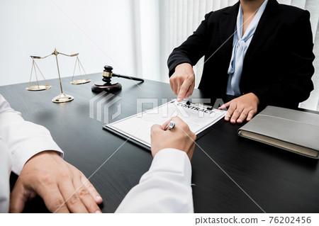 A woman lawyer or a judge counseling clients about judicial justice and prosecution with scales, judges gavel, legal documents legal services concept A woman lawyer or a judge counseling clients about judicial justice and prosecution with scales, judges gavel, legal documents legal services concept 76202456