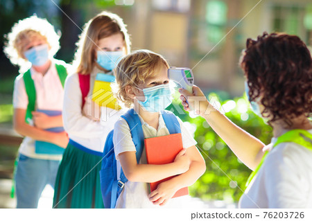 Temperature check at school. Child in mask. 76203726
