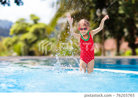 Child in swimming pool. Tropical vacation 76203765