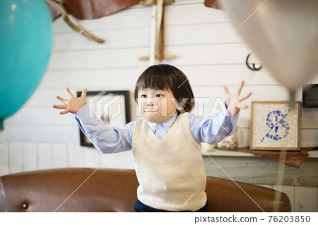 Boys playing with balloons Boys playing with balloons 76203850