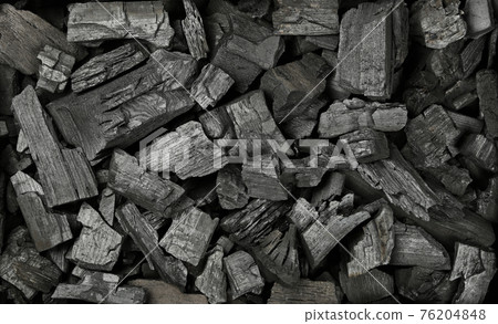 Background texture of many black charcoal pieces 76204848
