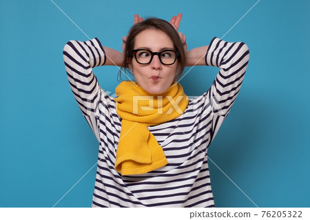 Young caucasian woman in glasses making fish face 76205322