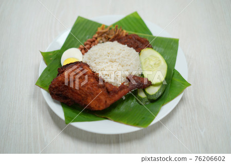 Nasi Lemak dish with chicken drum stick on white wooden verneer 76206602
