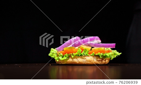Craft burger is cooking on black background. Consist: sauce, lettuce, tomato, red onion, pickle, cheese, bacon, air bun and marbled meat beef. Craft burger is cooking on black background. Consist: sauce, lettuce, tomato, red onion, pickle, cheese, bacon, air bun and marbled meat beef. 76206939