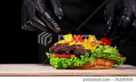 Craft burger is cooking. Consist: red sauce salsa, lettuce, red onion, pickle, cheese, chilli green pepper, air bun and marbled meat beef. Craft burger is cooking. Consist: red sauce salsa, lettuce, red onion, pickle, cheese, chilli green pepper, air bun and marbled meat beef. 76206989