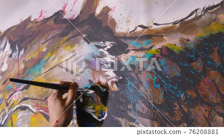 Artist designer draws an eagle on the wall. Craftsman decorator paints a picture with acrylic oil color brush. Close-up dark magic cinematic look. Artist designer draws an eagle on the wall. Craftsman decorator paints a picture with acrylic oil color brush. Close-up dark magic cinematic look. 76208881