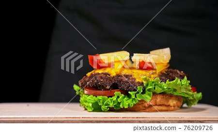 Craft burger is cooking. Consist: red sauce salsa, lettuce, red onion, pickle, cheese, chilli green pepper, air bun and marbled meat beef. Craft burger is cooking. Consist: red sauce salsa, lettuce, red onion, pickle, cheese, chilli green pepper, air bun and marbled meat beef. 76209726