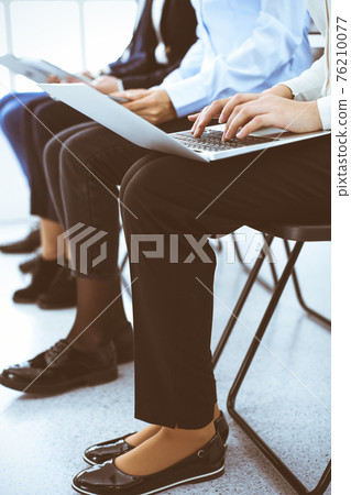 Group of business people working in office, close-up. Businesswoman typing on laptop. Conference, training or meeting concepts Group of business people working in office, close-up. Businesswoman typing on laptop. Conference, training or meeting concepts 76210077