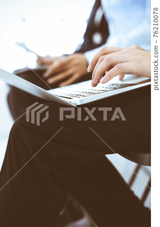 Group of business people working in office, close-up. Businesswoman typing on laptop. Conference, training or meeting concepts Group of business people working in office, close-up. Businesswoman typing on laptop. Conference, training or meeting concepts 76210078
