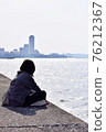 A woman sitting at the beach and twilight 76212367
