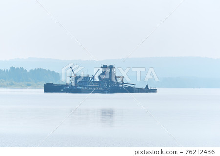 floating sand mining plant on the river in the morning fog 76212436