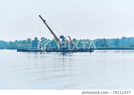 dredging boat is working to deepen the fairway on the river 76212437