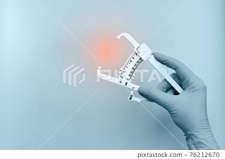 Hand with a device for measuring subcutaneous fat. Hand with a device for measuring subcutaneous fat. 76212670