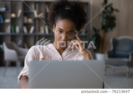 Pensive biracial woman work on laptop thinking Pensive biracial woman work on laptop thinking 76213647