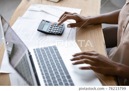 African American woman manage budget on computer 76213799