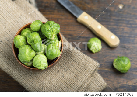 Brussels sprouts on rustic wooden table. Brussels sprouts on rustic wooden table. 76214365