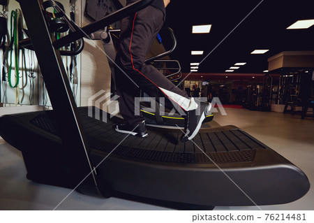 Running on a treadmill in the gym. Running on a treadmill in the gym. 76214481