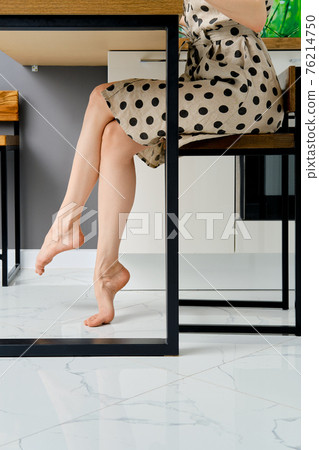 Barefoot female legs under the table Barefoot female legs under the table 76214750