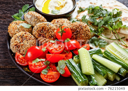 lamb meatballs with veggies and hummus, top view lamb meatballs with veggies and hummus, top view 76215049