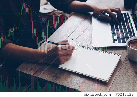 Trader holding in hands researching stock market to proceed right investment solutions. Trader holding in hands researching stock market to proceed right investment solutions. 76215122