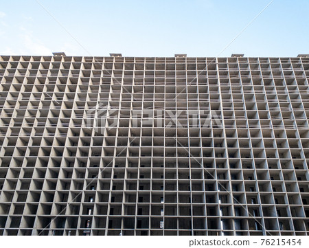 High-rise unfinished apartment building. 76215454