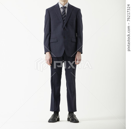 Man standing in suit, white background 76217324