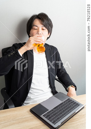 A man drinking beer at a business hotel A man drinking beer at a business hotel 76218528