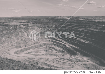 Aerial view industrial of opencast mining quarry with lots of machinery at wo Aerial view industrial of opencast mining quarry with lots of machinery at wo 76221363