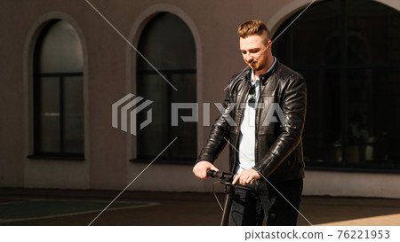Modern man riding electric scooter in the city 76221953