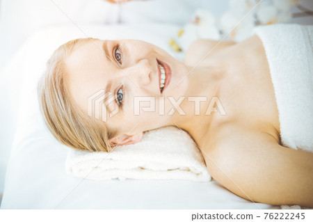 Happy woman smiles before spa procedures getting. Beauty and joy concept 76222245
