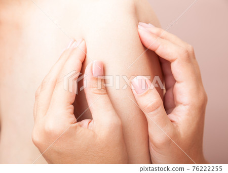 Woman receiving osteopathic treatment of her shoulder Woman receiving osteopathic treatment of her shoulder 76222255