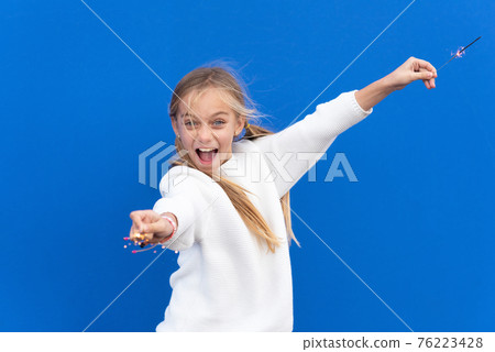 Little girl playing with Bengal lights 76223428