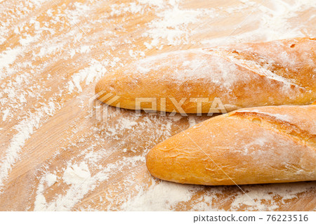Artisanal French baguettes on a table 76223516