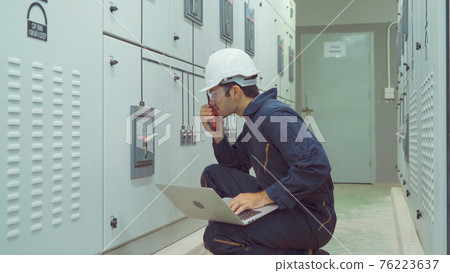 An engineer man or worker, people using a laptop computer, working in electrical room. Power energy motor machinery cabinets in control or server room, operator station network in industry factory. An engineer man or worker, people using a laptop computer, working in electrical room. Power energy motor machinery cabinets in control or server room, operator station network in industry factory. 76223637