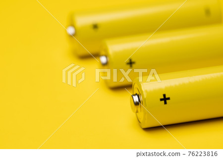 Yellow alkaline batteries colorful background Yellow alkaline batteries colorful background 76223816
