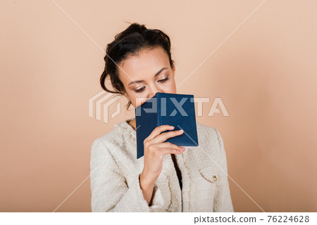 Successful young business woman with hands folded smiling over grey background 76224628