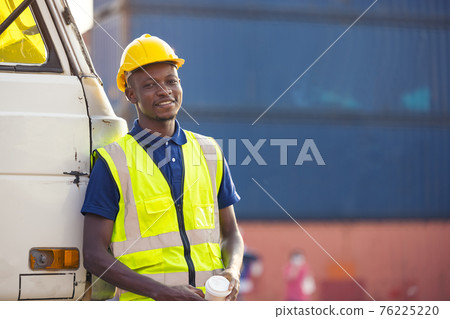 African American businessman drinking coffee, black man have coffee break at worksite outdoors container background African American businessman drinking coffee, black man have coffee break at worksite outdoors container background 76225220